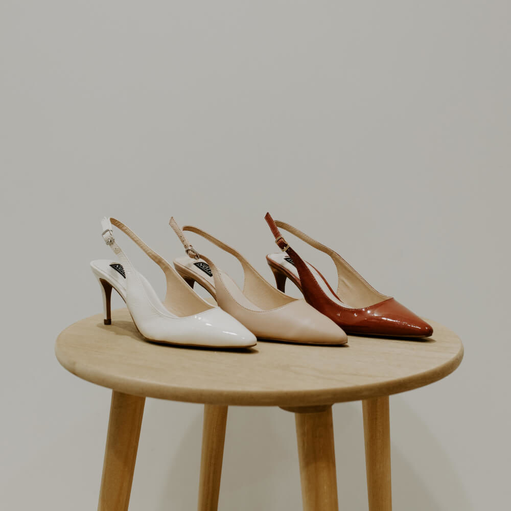 Picture of three high heeled shoes on a stool