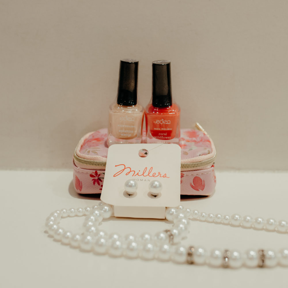 Picture of a pearl necklace and nail polish
