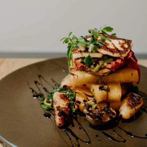 Picture of fries stacked with halloumi and balsamic dressing