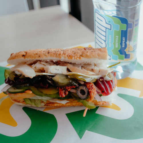 Picture of a subway sandwich and pump water bottle