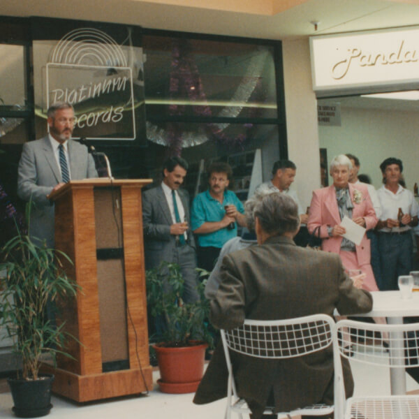 Historic picture of man speaking from podium to audience