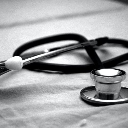 Picture of black and white stethoscope sitting on bench